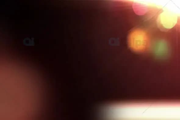 Warm Bokeh Glow with Light Rays on Dark Background