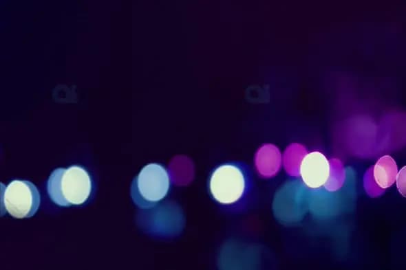 Moody Blue and Purple Bokeh Lights on Dark Background