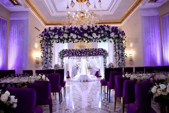 Grand Wedding Hall with Floral Arch and Purple Decor