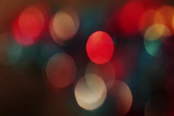 Warm Red and Teal Bokeh Lights on Dark Background for Festive Motion Graphics