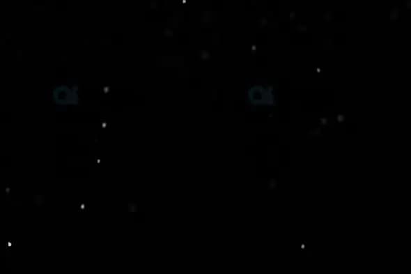 Light Snowfall on Black Background – Sparse Winter Particle Motion