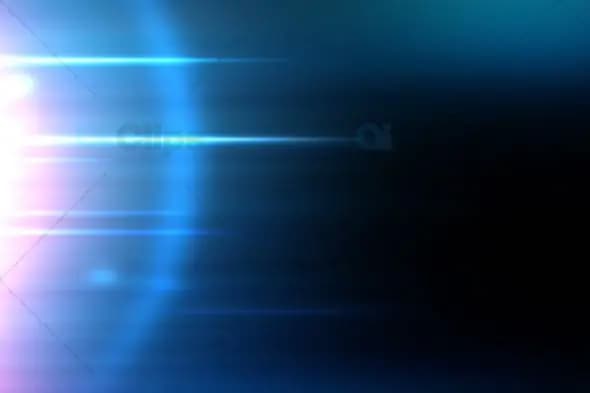 Blue Light Streaks with Lens Flare on Dark Background
