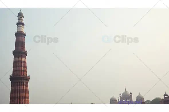 Qutub Minar and Historic Domes in Foggy Delhi Skyline