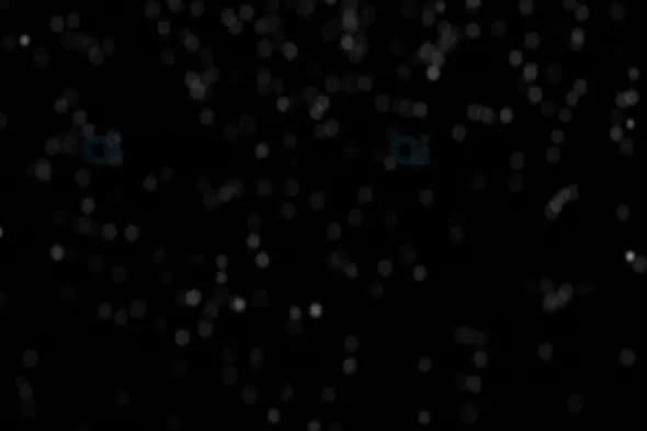 Soft Bokeh Snowfall on Black Background – Atmospheric Winter Particles