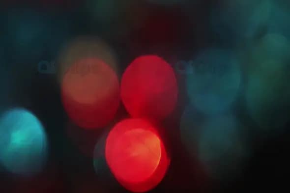 Bold Red and Teal Bokeh Lights on Dark Background for Artistic Motion Graphics