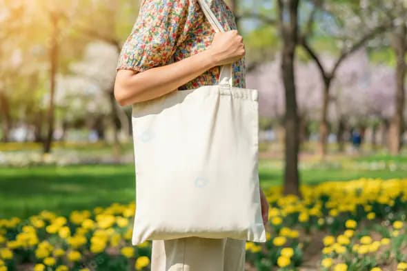 Stylish Woman Carrying Eco-Friendly Canvas Tote Bag in Park