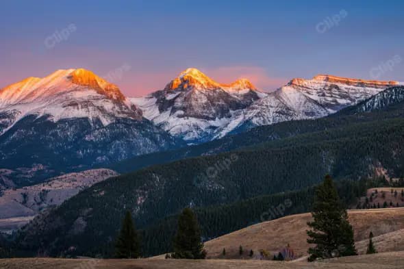 Majestic Snow-Capped Mountains at Sunrise with Forest View