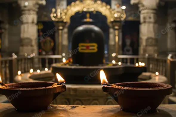 Sacred Shiva Lingam with Oil Lamps in Traditional Hindu Temple Interior