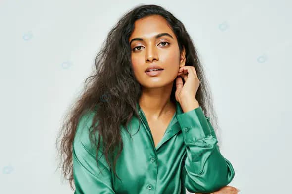 Elegant Woman in Green Satin Shirt on Minimalist Background