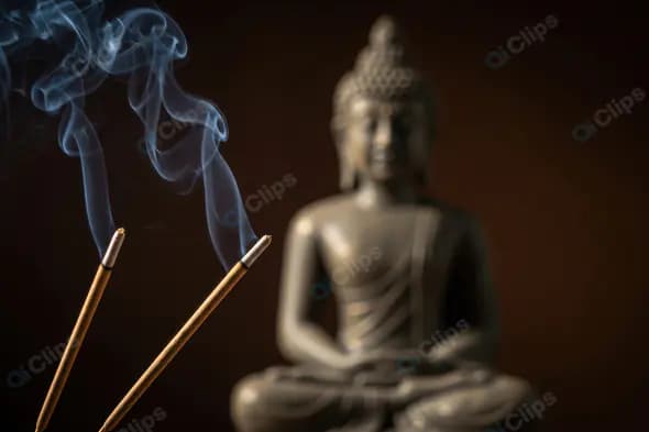 Meditation Buddha Statue with Burning Incense Sticks and Calm Smoke