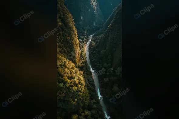 Aerial View of River Flowing Through Lush Green Canyon