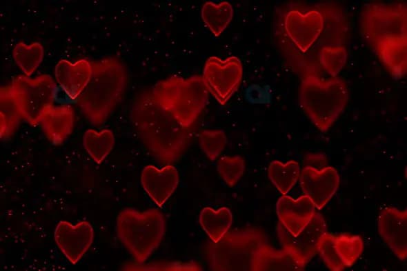 Glowing Red Hearts with Particle Sparkle on Black Background