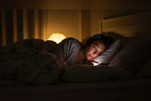 Late Night Phone Scrolling in Dimly Lit Bedroom