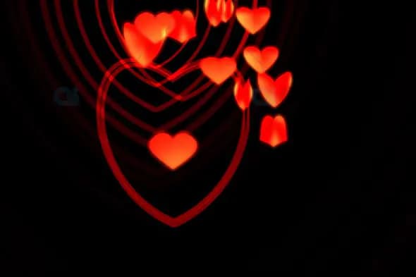 Glowing Red Heart Lines with Floating Hearts on Black Background