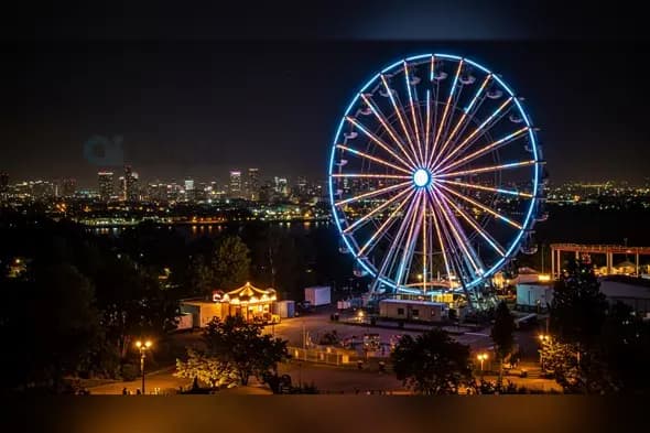Vibrant Nighttime Ferris Wheel Over Urban Skyline