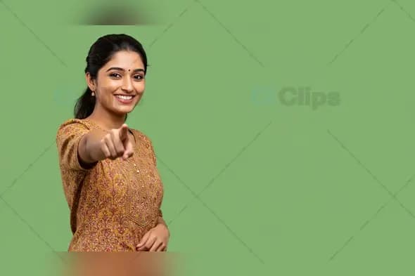 Young Woman with a Smile Pointing on a Bold Green Background