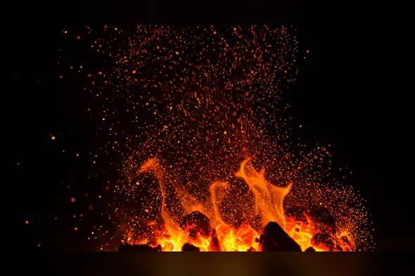 Dynamic Rising Flames with Embers and Sparks on Dark Background