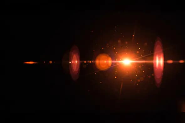 Fiery Red-Orange Lens Flare with Circular Orbs and Glow Particles