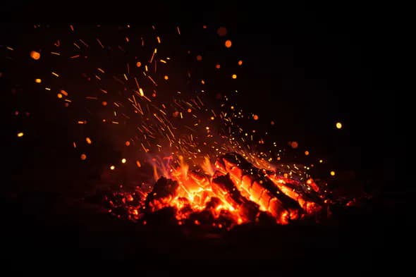 Burning Logs with Flying Orange Sparks Texture Background for Fire Overlays