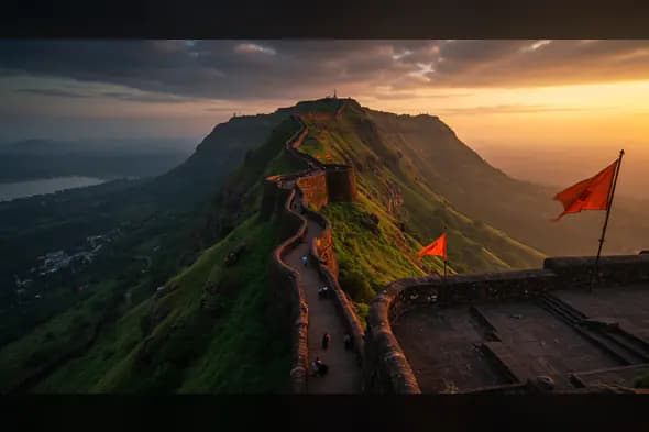 Majestic Indian Fort with Saffron Flags at Sunrise in Scenic Hills