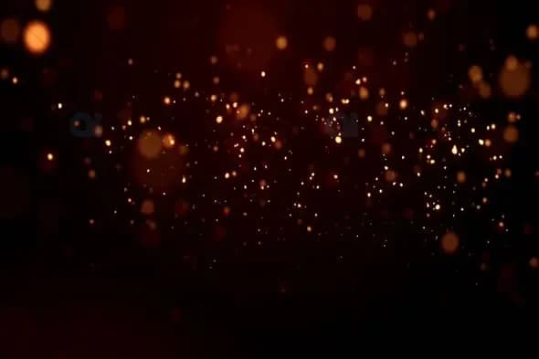 Golden Sparkling Particles on Dark Background