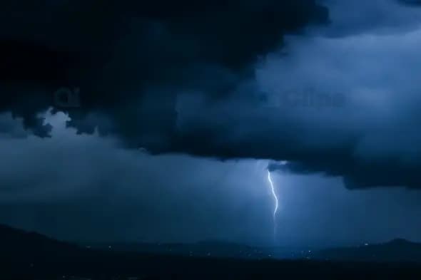 Dramatic Lightning Strike Over Mountain Landscape at Night