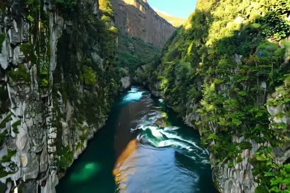 Turquoise River Flowing Through Dramatic Rocky Canyon