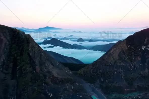 Majestic Mountain Valley Filled with Rolling Clouds at Dawn