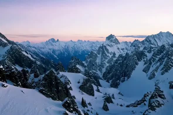 Snowy Mountain Range at Twilight with Pink Sky
