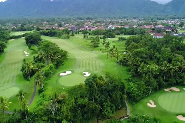 Tropical Golf Course with Mountain Backdrop and Luxury Homes