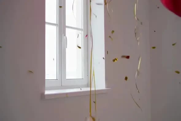 Falling Gold Confetti by Window with Natural Light