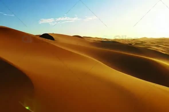 Golden Sand Dunes Under Clear Blue Sky at Sunset