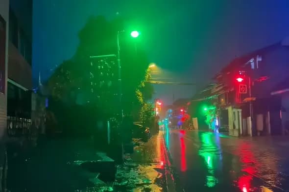 Neon-Lit Rainy Street with Vibrant Color Reflections at Night