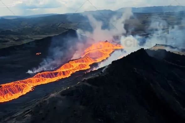 Molten Lava Flow Through Volcanic Mountain Landscape