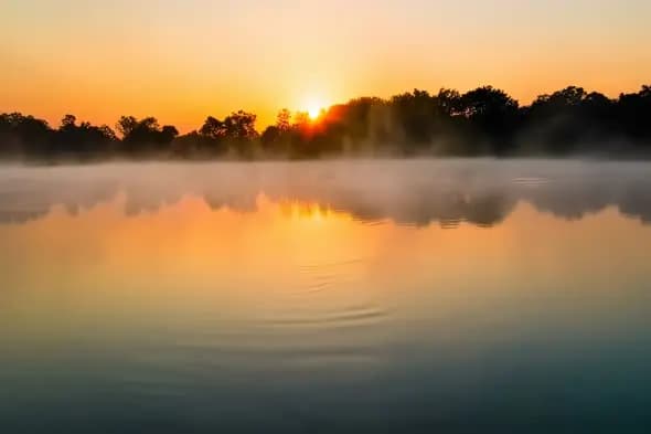Misty Lake Sunrise with Golden Sky Reflection