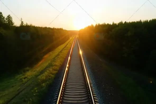 Golden Sunset Over Railway Tracks Through Forest