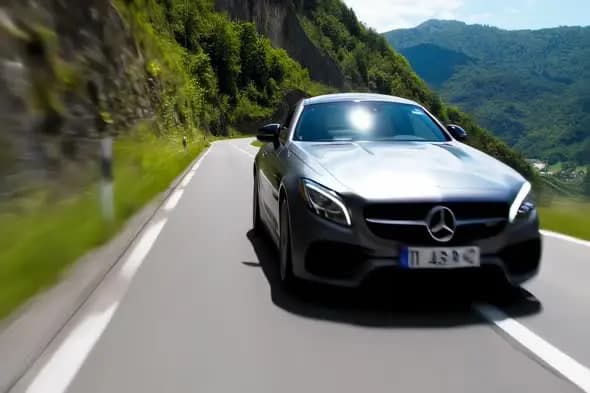Mercedes Benz Luxury Coupe Driving on Mountain Road