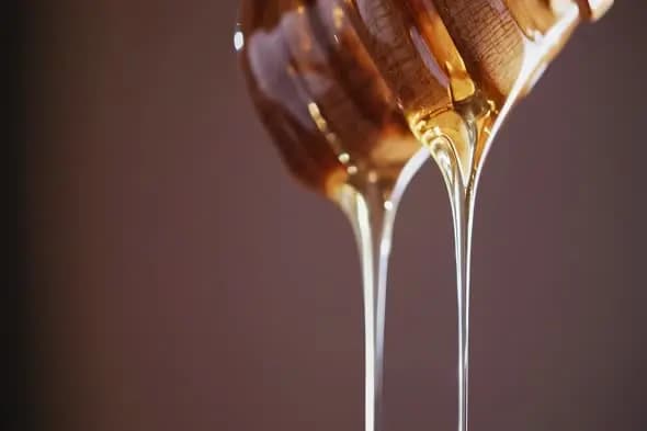 Smooth Honey Streams Pouring in Macro Shot