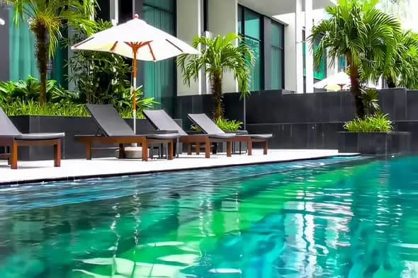 Luxury Resort Pool with Emerald Water and Sun Loungers