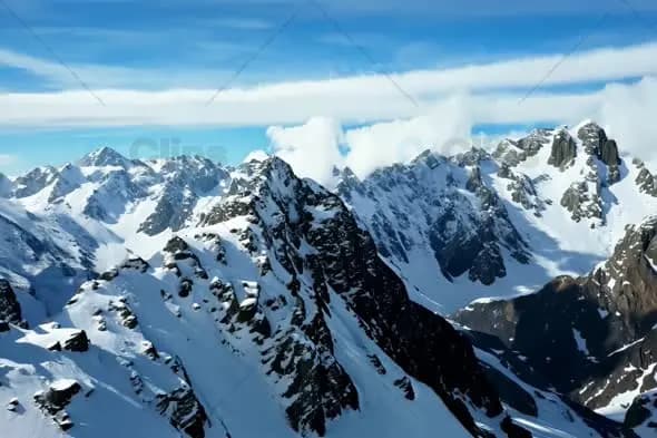Majestic Snow Capped Mountain Range Under Bright Blue Sky
