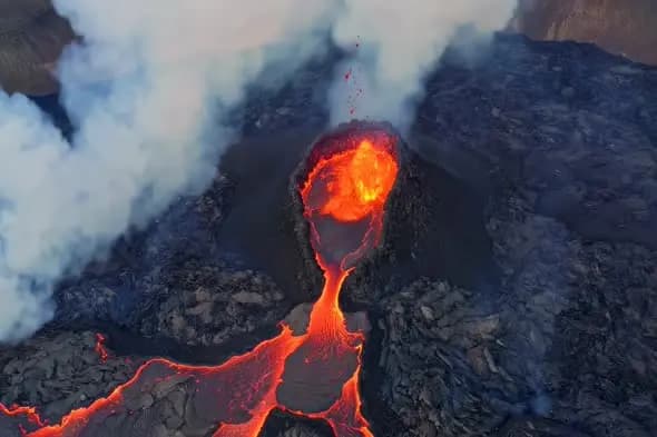 Volcanic Eruption with Active Lava Flow and Smoke Plumes