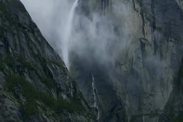Misty Mountain Waterfall Cascading Down Dramatic Rocky Cliff
