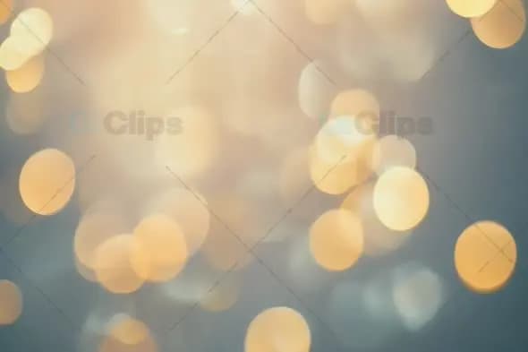 Ethereal Golden Bokeh Lights on Soft Blue Background