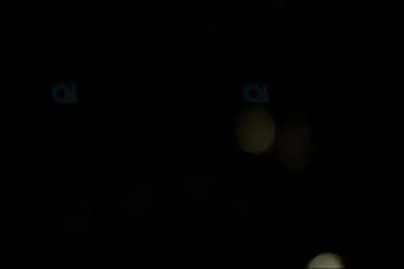Dim Golden Bokeh Lights on Black Background