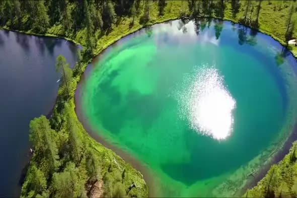 Aerial View of Turquoise Mountain Lake with Sunlight Reflection
