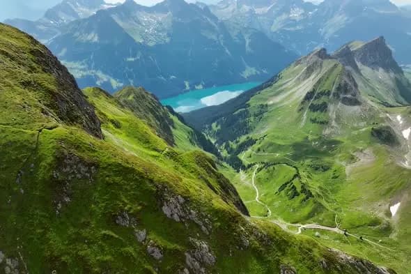 Aerial View of Alpine Mountain Lake and Winding Valley Road