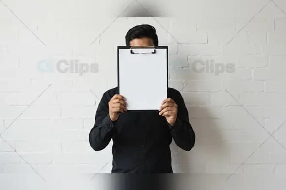 Man Holding Blank Clipboard in Front of Face