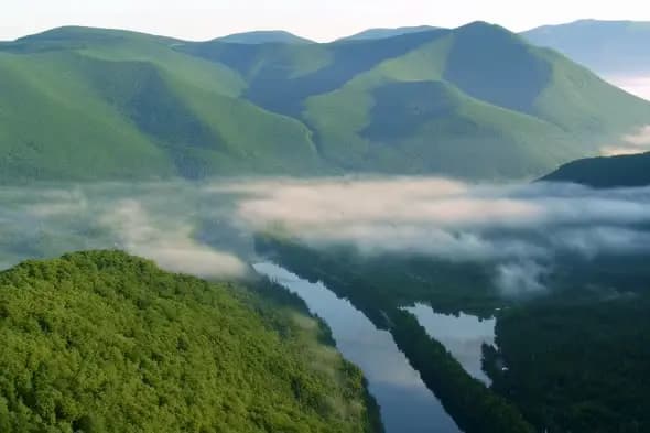 Misty Mountain Lake Valley with Rolling Green Hills at Dawn