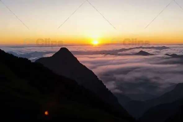 Mountain Peak Sunrise Above Sea of Clouds