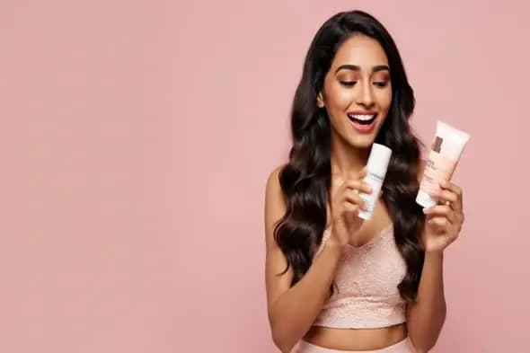 Beauty Model Displaying Skincare Products on Pink Background
